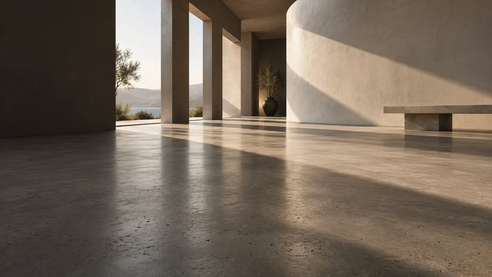 Architectural concept of a sunlit interior with a smooth concrete floor and sculptural stone walls
